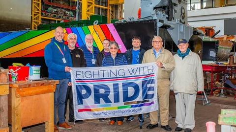 Undated handout photo issued by Portsmouth Historic Quarter of members of Fighting with Pride (Roly Woods, left) in front of Landing Craft F8 at Portsmouth Historic Dockyard. Royal Navy Landing Craft Foxtrot 8 which was used in the Falklands War has been wrapped in Pride colours to mark the 25th anniversary of the lifting of the ban on gay people serving in the UK armed forces. 