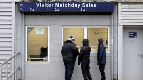 Derby County fans collect tickets outside the ground at Deepdale Stadium, Preston, ahead of the Sky Bet Championship match between Preston North End and Derby County on 23 November 2024