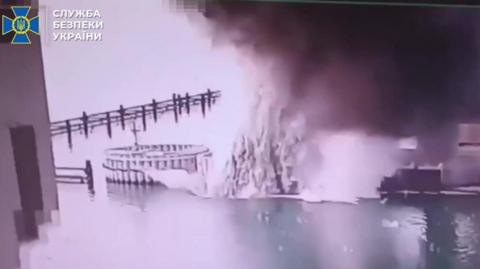 A still image grabbed from a handout video made available by the Ukrainian Security Service (SBU) on 03 June 2025 shows an explosion at the Crimea bridge