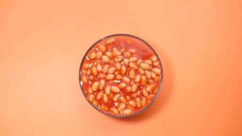 Glass bowl of baked beans from above