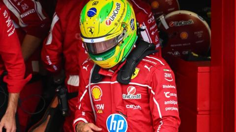 Lewis Hamilton in the pit lane after getting out of his Ferrari to retire from the Sao Paulo Grand Prix