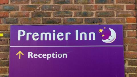 Stock image of a purple sign on a Premier Inn 