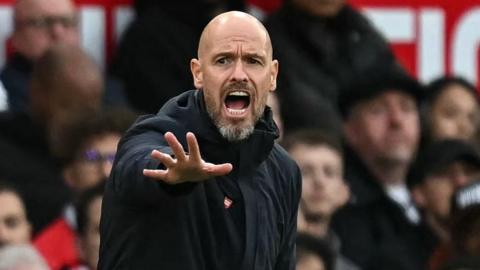 Manchester United manager Erik ten Hag shouts with his right arm outstretched