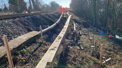 A view from the side of the Brighton Main Line of the landslip at Tinsley Green.