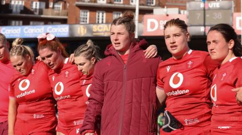 Kate Williams of Wales speaks to the players at the end of the match