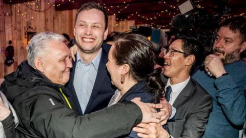 Chairman of Demokraatit, Jens-Frederik Nielsen (C), celebrates during the election party at Demokraatit by cafe Killut in Nuuk, March 11, 2025