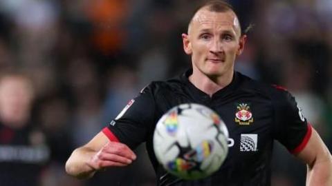 Will Boyle stares at the ball as he chases after it during a game