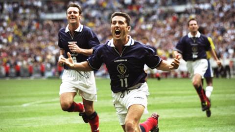 John Collins of Scotland celebrates after scoring from the penalty spot during a World Cup game against Brazil in 1998