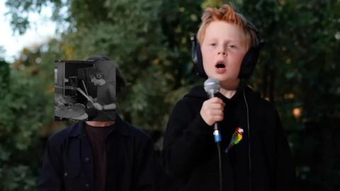 Ginger boy holds a microphone