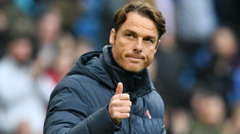 Burnley head coach Scott Parker gives a thumbs up to the crowd