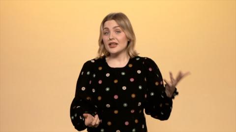 Mared Parry who has blonde hair and a nose ring in a black dress with colourful circles