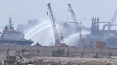 Social media video shows tugboats firing water jets at vessels on fire in Damietta port, Egypt (29 July 2026)
