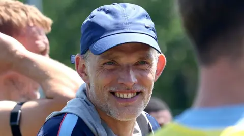 England manager Thomas Tuchel smiles at training