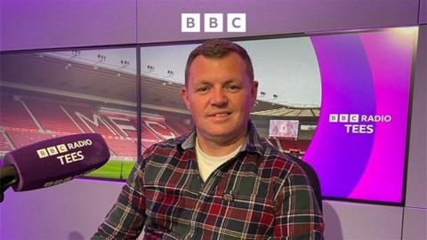 Middlesbrough head of football Kieran Scott next to a BBC Radio Tees microphone