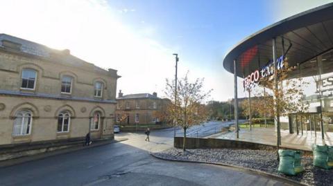 Tesco Extra on Eagle Street - with a sunny background and some older buildings opposite 