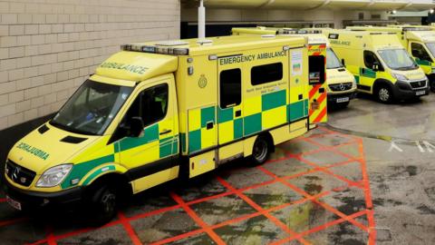 A number of ambulance vehicles parked up outside a hospital in the north-west of England. 