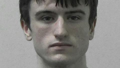 Mugshot of Logan MacPhail, he is a young man with a thin face and brown hair