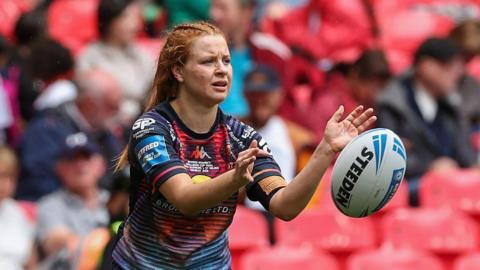 Wigan's Grace Banks throws a pass in a training session