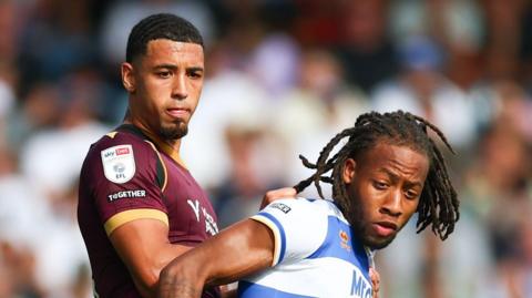 Chris Forino-Joseph of Bolton Wanderers and Rumarn Burrell of Queens Park Rangers battle for the ball