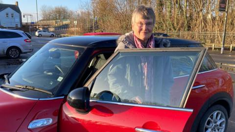 June Scatchard getting out of her car