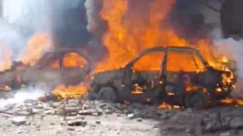 A screengrab from social media video shows vehicles on fire in Tehran