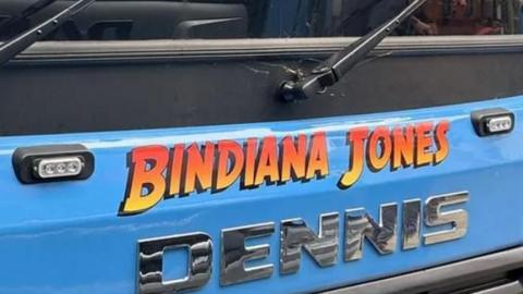 A close up picture of the front of a lorry, its painted blue and has Bindiana Jones written on it 