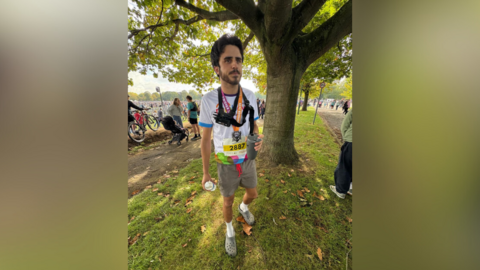Runner wearing Crocs standing under tree at Robin Hood Half Marathon