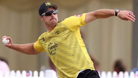 Marchant de Lange holds his arm back to throw a ball while fielding during a match