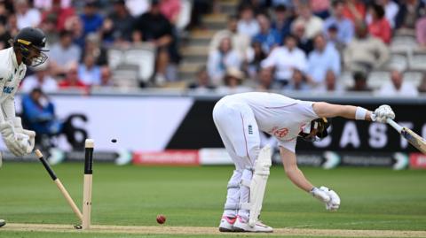 Jacob Bethell is bowled by a ball that keeps low
