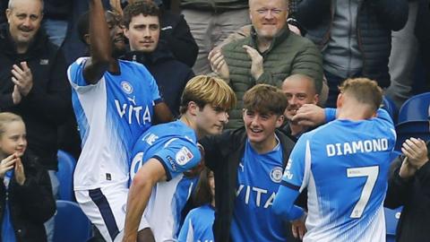 Nathan Lowe celebrates with his Stockport team-mates