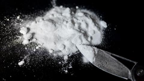 Generic image of a small pile of a white powdered drug on a black background