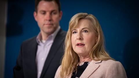 Melissa Hortman speaking with a man in the background