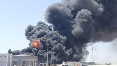 Smoke and fire billows over a fuel depot in Port Sudan.