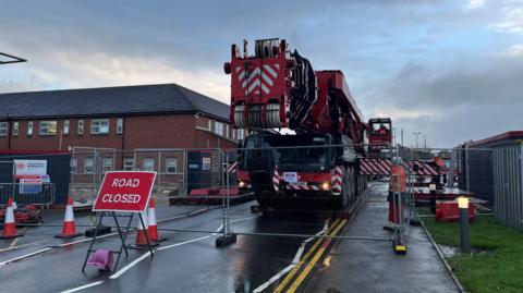 Crane outside the entrance of the hospitals accident and emergency department