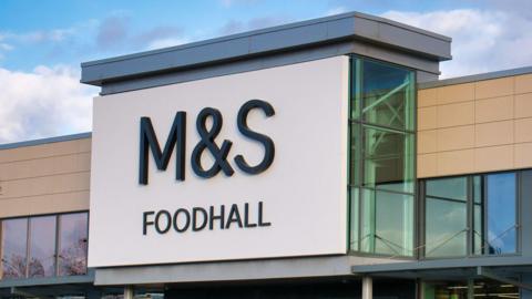 A large M&S Foodhall sign above the entrance to one of its branches