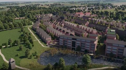 A computer generated aerial image of what the large housing development at Otterpool Park could look like, with rows of houses and blocks of flats next to a green park area with trees.