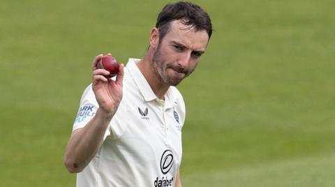 Toby Roland-Jones holds up thee ball after taking five Kent wickets at Lord's