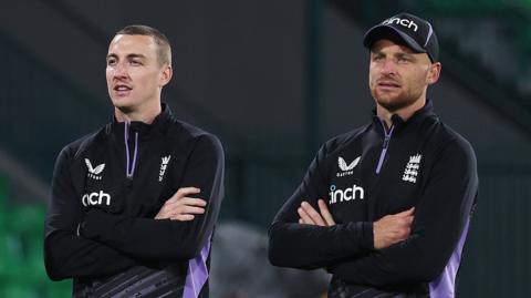 England players Harry Brook (left) and Jos Buttler (right) look on during training