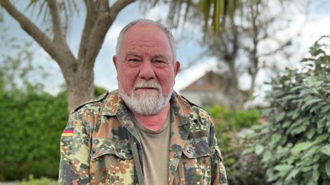 Environmentalist Bob Tompkins in front of some hedges