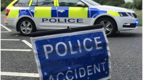 A police accident sign in front of a police car