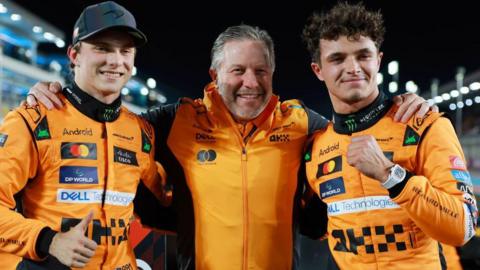 McLaren's Oscar Piastri, CEO Zak Brown and Lando Norris pose for a photograph at the Qatar Grand Prix