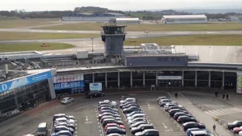 Entrance to Leeds Bradford Airport with cars parked outside