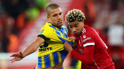 Nathan Wood and Hugo Ekitike battle for possession
