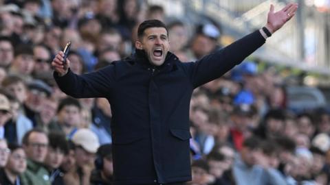 Portsmouth boss John Mousinho appeals on the touchline