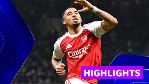 Gabriel Jesus celebrates with arm in the air in red Arsenal kit