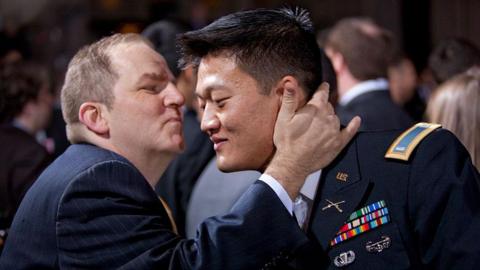 Lieutenant Dan Choi, an openly gay veteran, receives a kiss from his partner at the 2010 ceremony to repeal the 'Don't Ask, Don't Tell' law that prevented openly queer Americans from serving in the US military