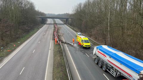 Emergency services clearing up road after lorry crash