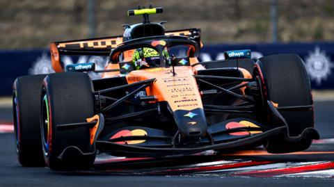 McLaren's Lando Norris drivers over a kerb during final practice for the Hungarian Grand Prix