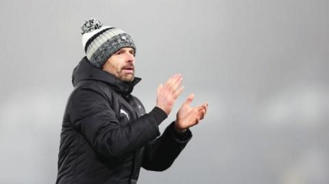 Derby County boss Paul Warne claps the fans