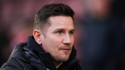 Crewe manager Lee Bell looked satisfied, head shot wearing warm waterproof jacket